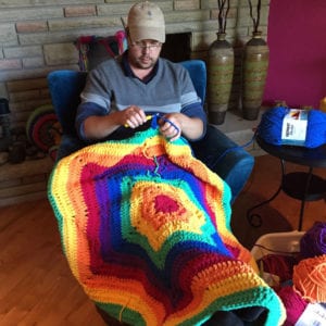 Mikey making the prototype of the Fluffy Unicorn Afghan to figure out yarn quantities
