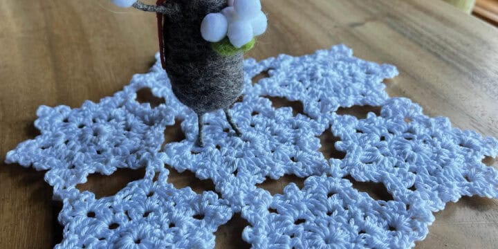 Crochet Snowflake Doily Pattern on Table with Mouse