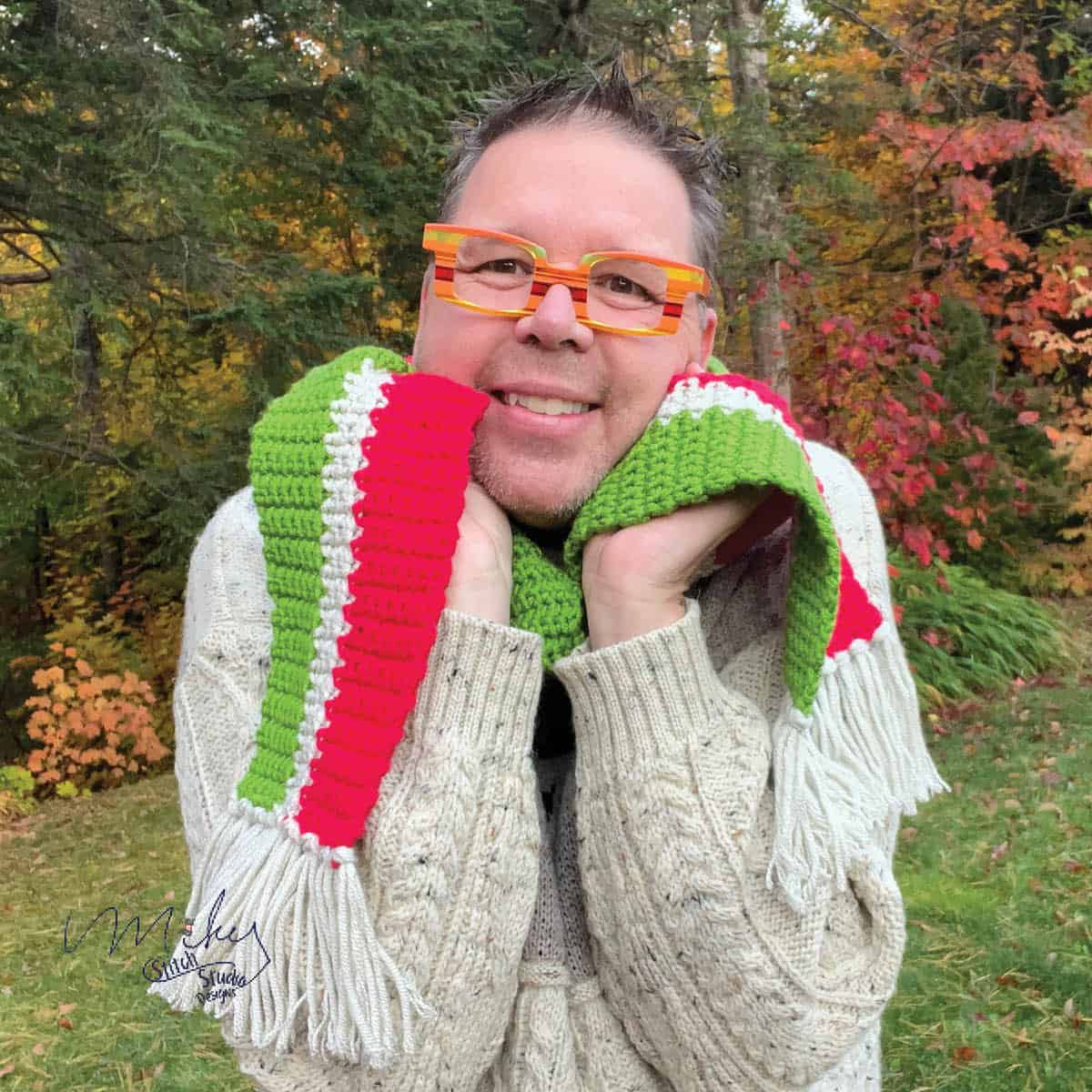 Cute christmas scarf being held by a man.