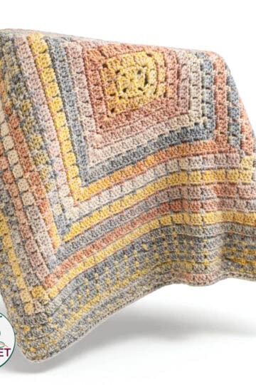 Colorful Tunisian entrelac crochet blanket with textured pattern.
