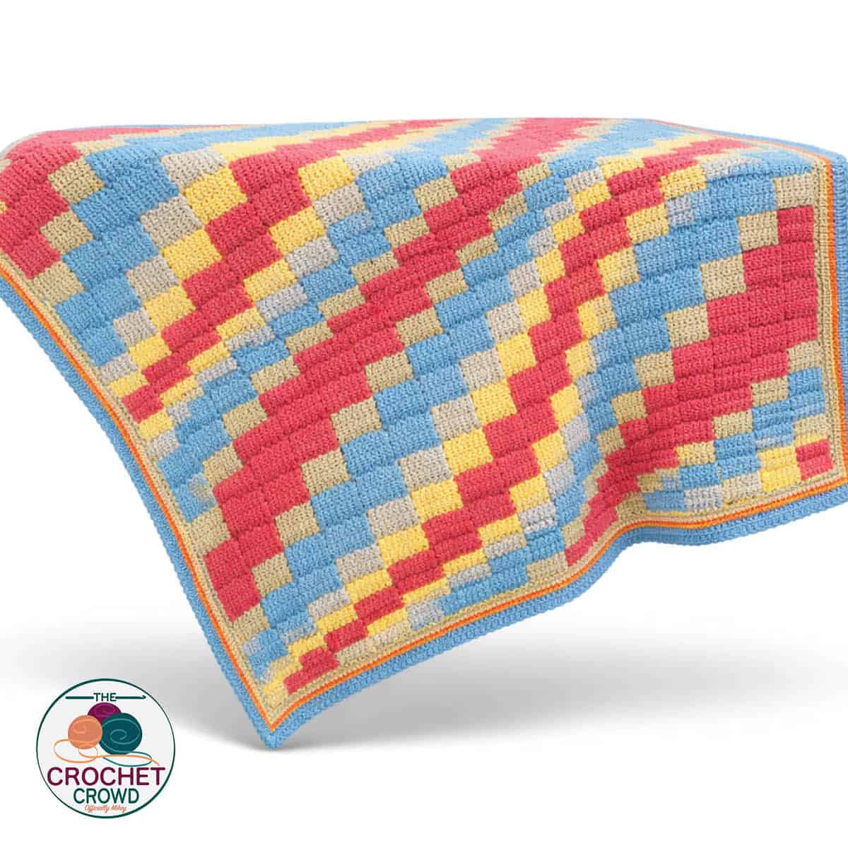 Colorful Tunisian crochet blanket with a geometric pattern in red, yellow, blue, and beige.